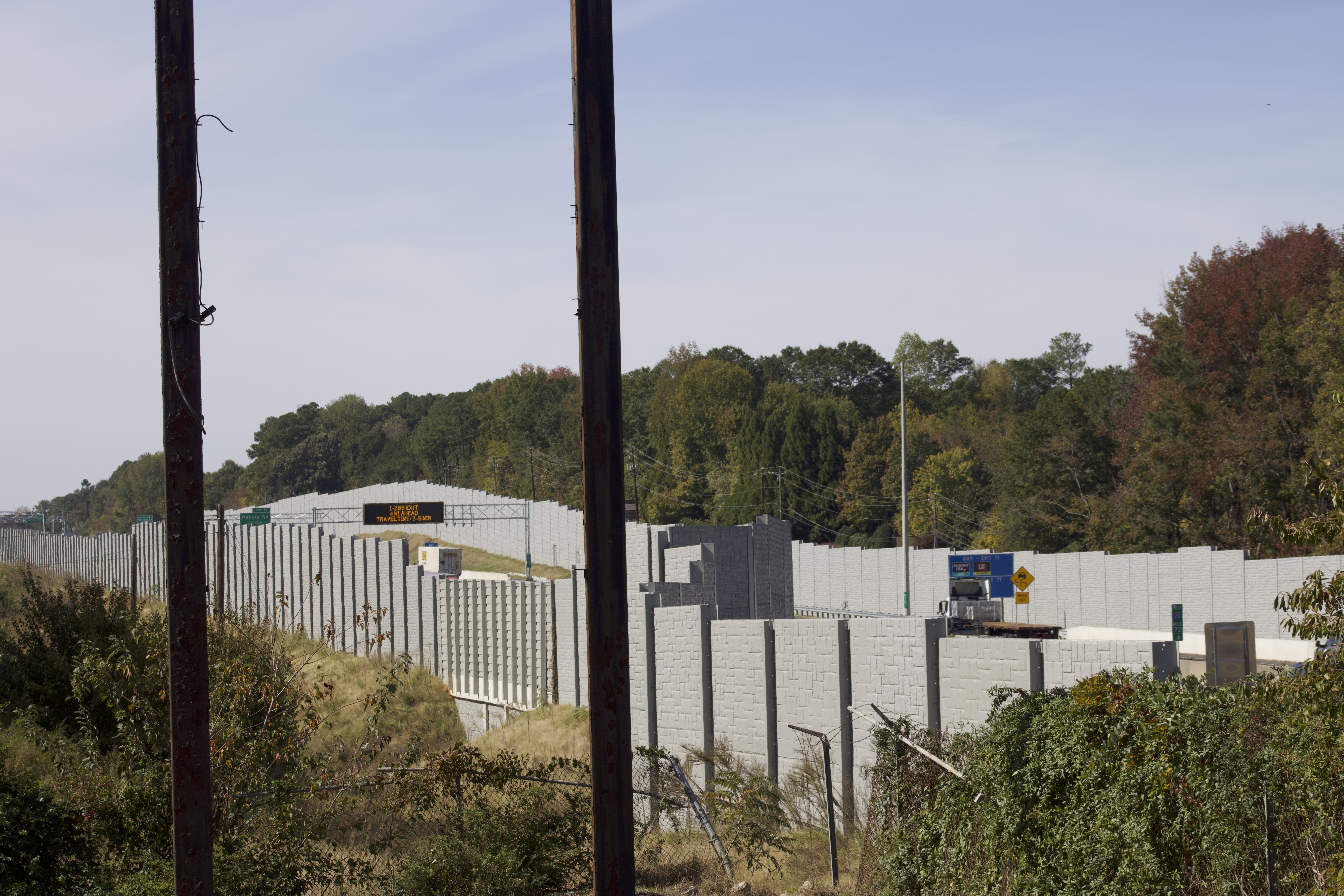 Close view of precast sound wall panels beside live traffic on I-20