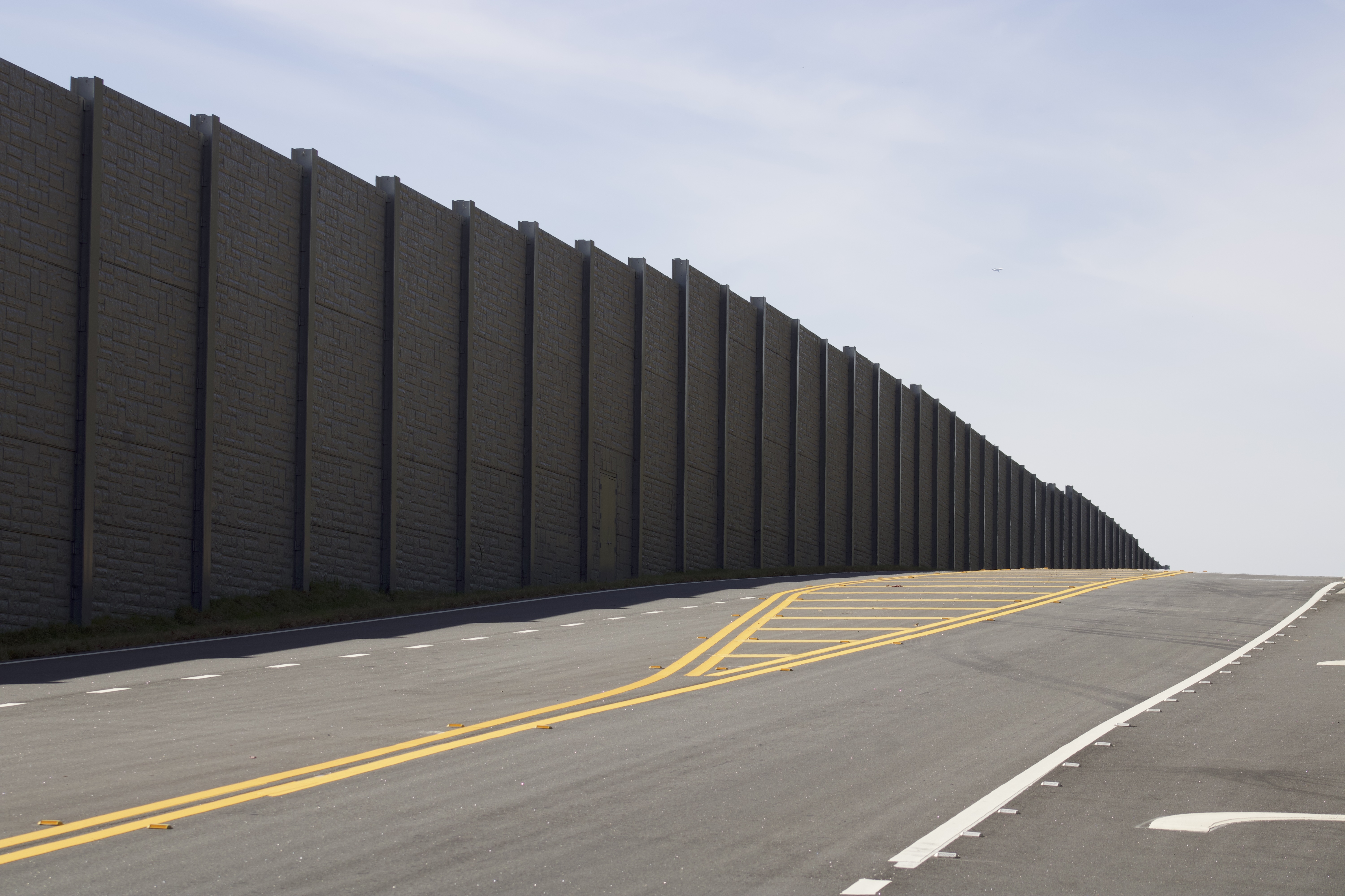 Close view of precast sound wall panels beside live traffic on I-20
